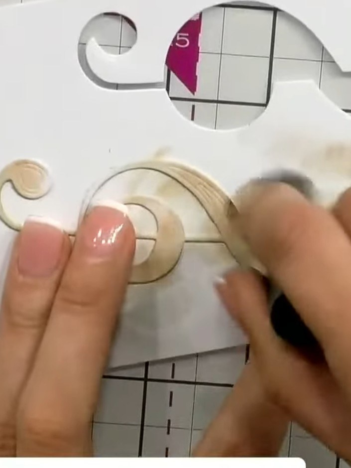 Step 3: Using the brown ink pad, deepen the colour in places on the embossed treble clef design. Focus on the raised a