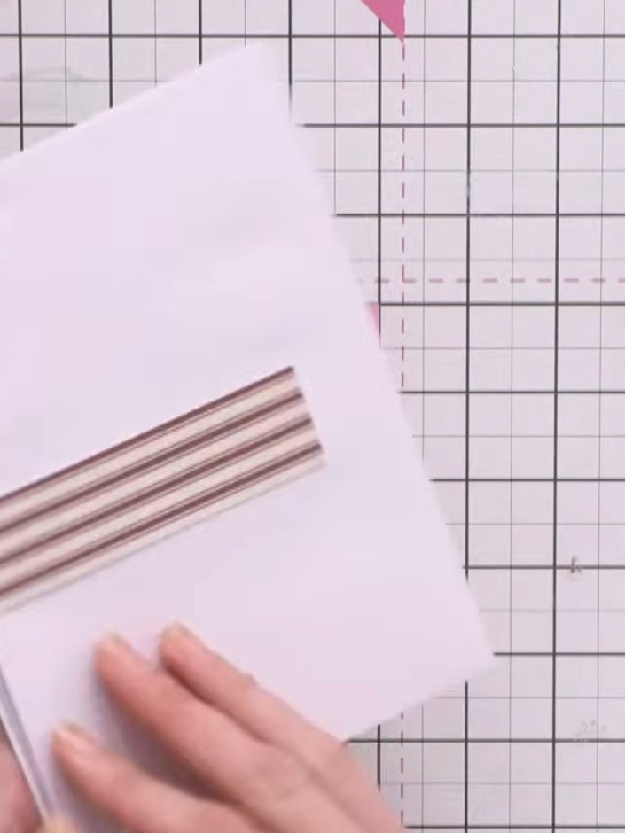 Step 10: Cover the back of the album with a piece of coordinating striped paper to conceal the closure mechanism and co