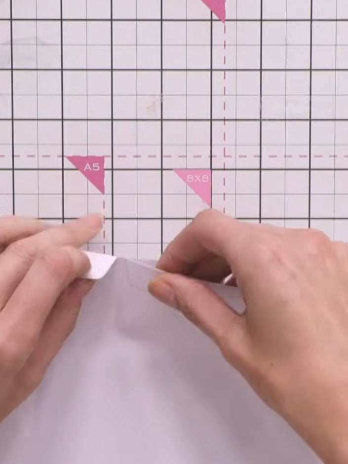 Step 3: Cut coordinating paper from your paper pad to approximately 7 by 7 inches and glue it onto the front cover of 