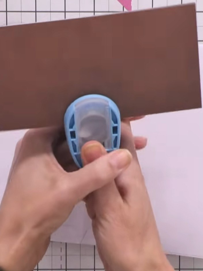 Step 5: Mark the placement for the circular opening on the side panel with a pencil. Use the 1-inch circle punch to cr