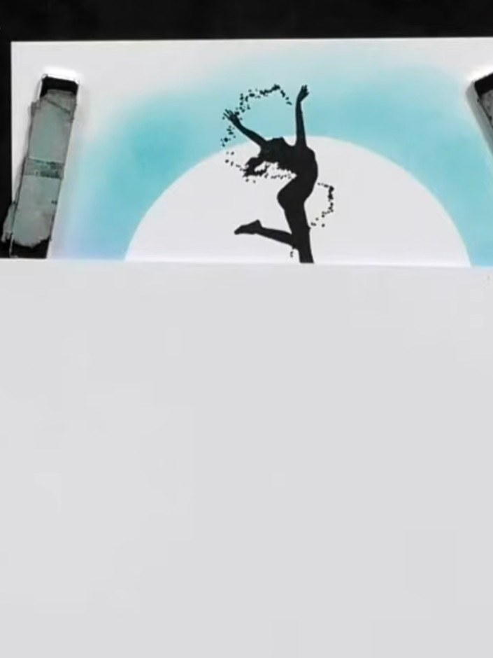 Step 4: Stamp the dancer silhouette clearly onto the white card panel using black ink. Position the stamp centrally ov