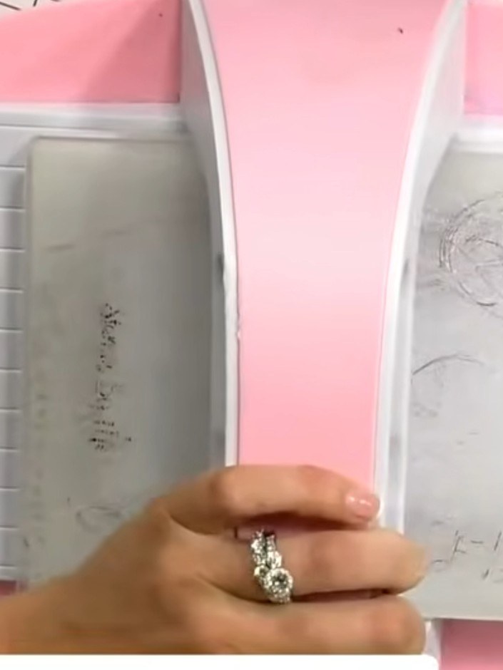 Step 3: Position the layered die-cut piece onto your card base, ensuring it is centred and aligned properly before adh