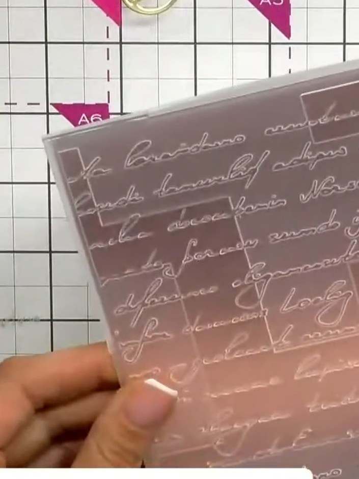 Step 2: Run the copper cardstock through an embossing machine with the Modern Script embossing folder to create a text