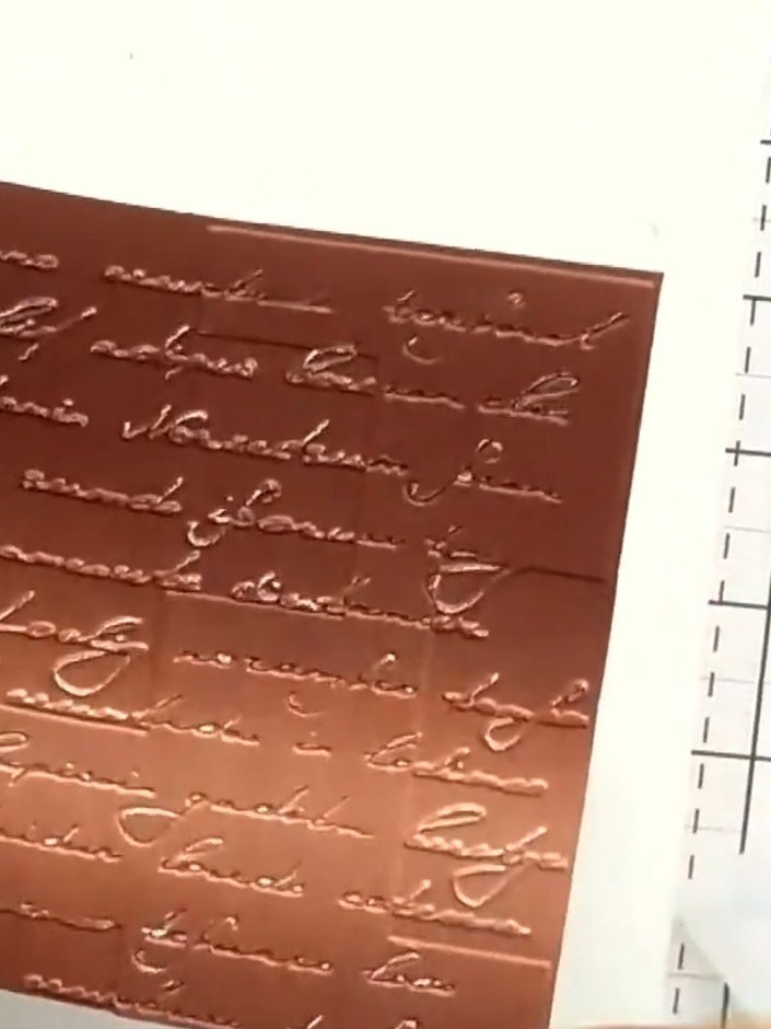Step 4: Optionally, sand back the embossed areas with a nail file to reveal the white core beneath the copper surface 