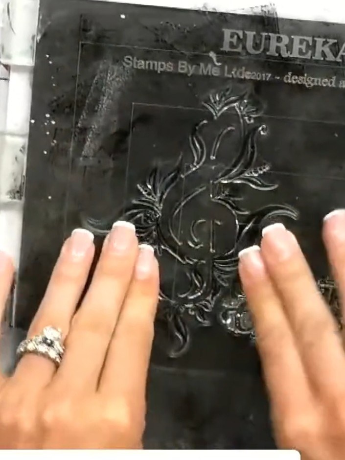 Step 7: Heat set the gold embossing powder using a heat tool, moving it over the stamped design until the powder melts
