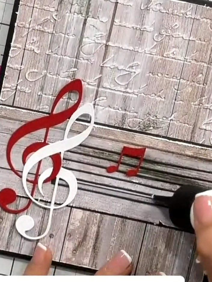 Step 5: Glue each musical note in place on the card, ensuring they are well adhered. Position the treble clefs and not
