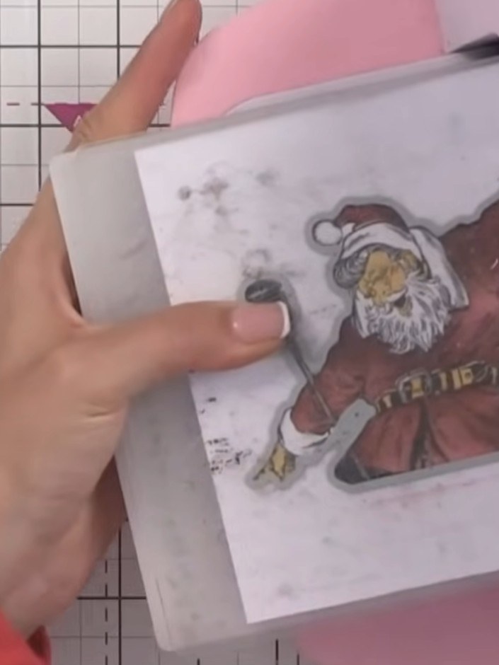 Step 10: For added dimension, bend the Santa's arm outward to create a pointing gesture. Add sparkle or glitter to his 