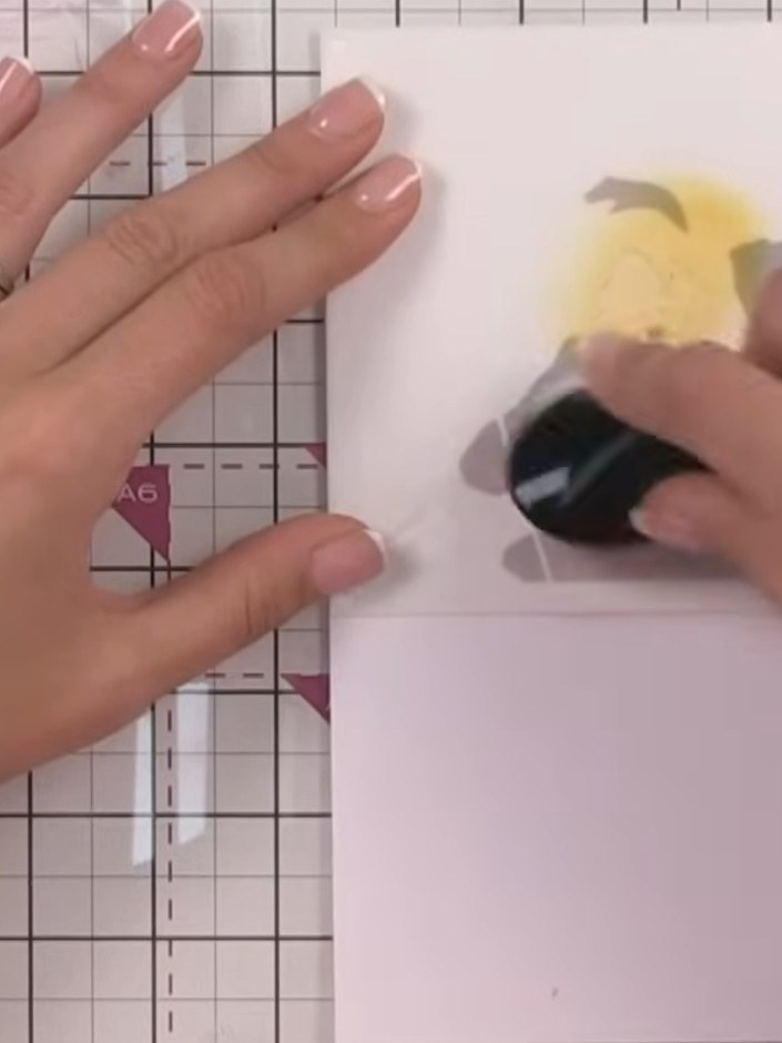 Step 4: Using an ink blending tool, blend a yellow or skin-tone colour through the stencil onto the hands, face and be