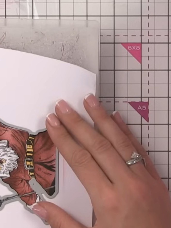Step 9: Die-cut the Santa image using the outline die from the Quattro D set, running it through your die-cutting mach