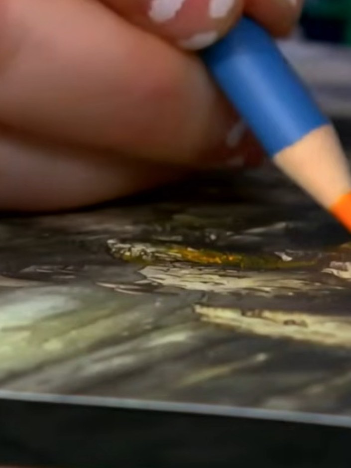 Step 7: Dip a damp paintbrush into water and blend the watercolour pencil colours on the mushrooms and forest scene to
