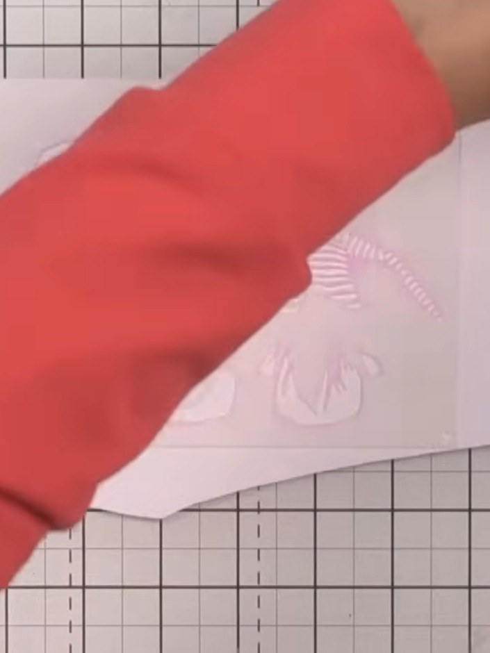 Step 2: Position stencil number one on your card, lining it up at the edge or using the heart alignment guide shown on