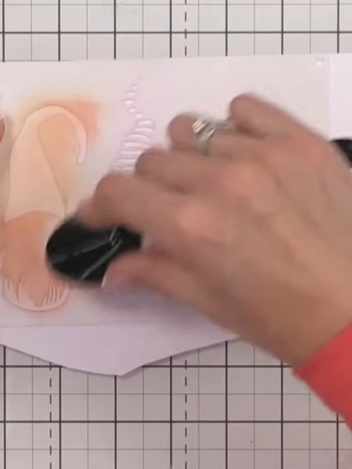 Step 3: Use an orange blending brush to apply ink through the first stencil, creating the hat colour for the first gno