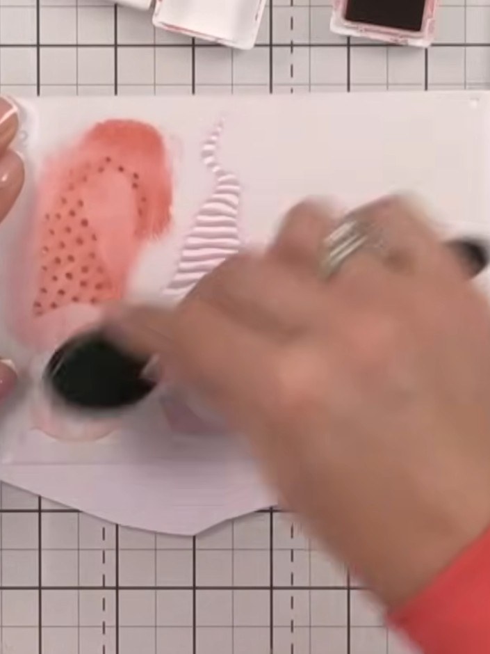 Step 5: Remove the first stencil and position the second stencil over the gnomes. This stencil shows the spots pattern