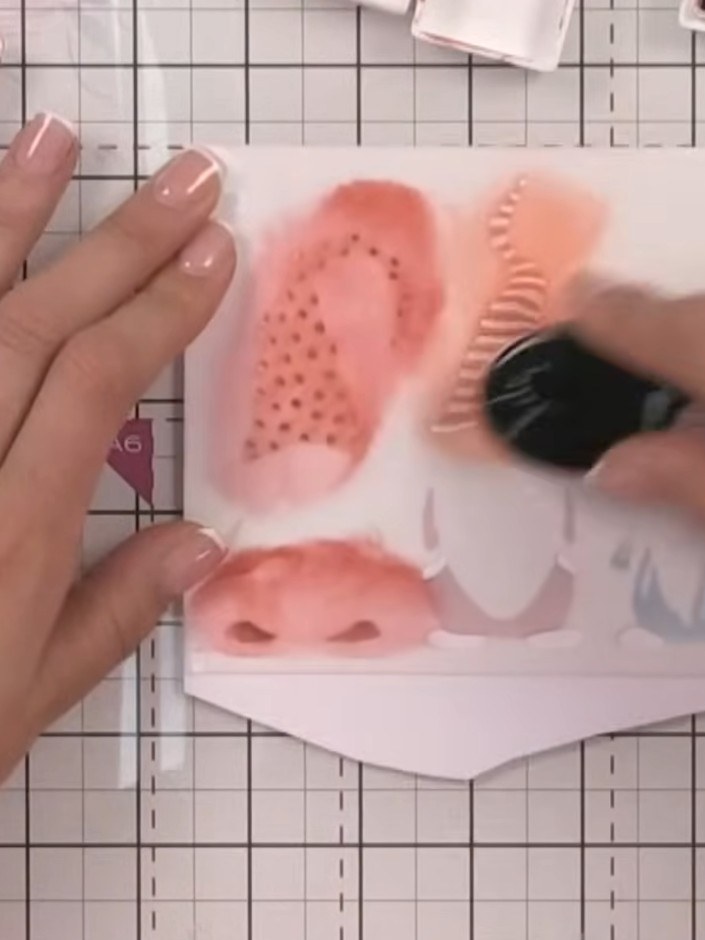 Step 6: Apply orange ink through the second stencil to add spots to the first gnome's hat and striped pattern to the s