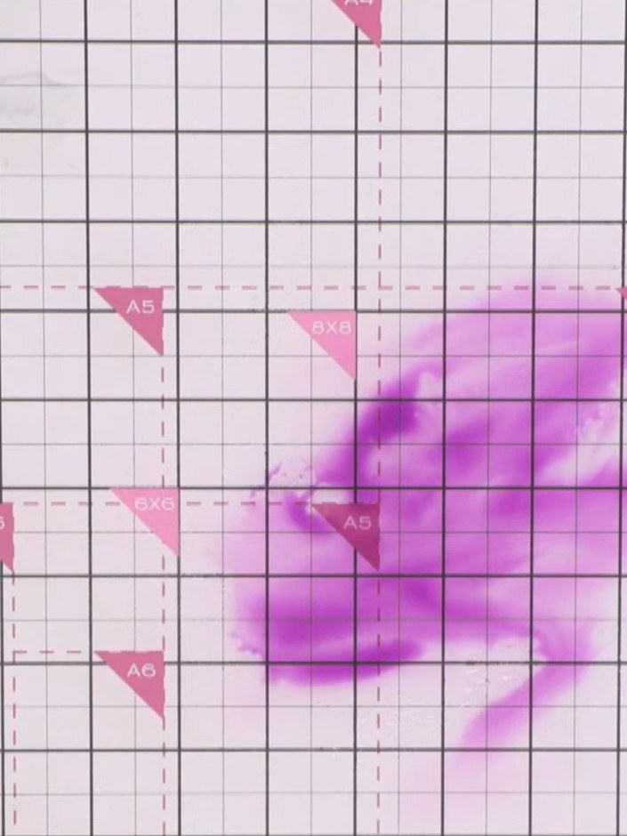 Step 3: Spray the purple ink puddle with water to create a wet, blended base. Use tissue to gently blend and spread th