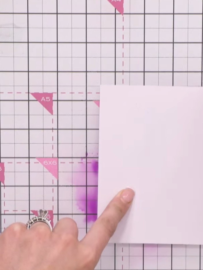 Step 4: Press your white card straight into the wet purple ink on the craft mat. Allow the card to absorb the colour a