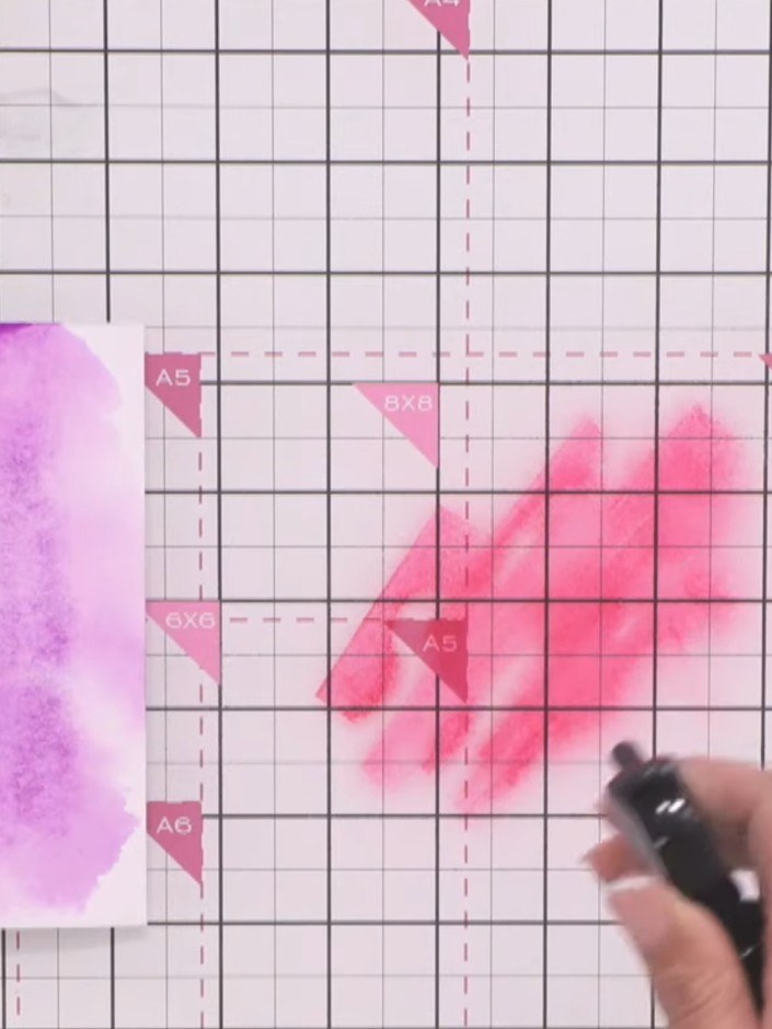 Step 5: Apply pink and purple ink to different areas of your watercolour paper, spraying with water as you work to ble
