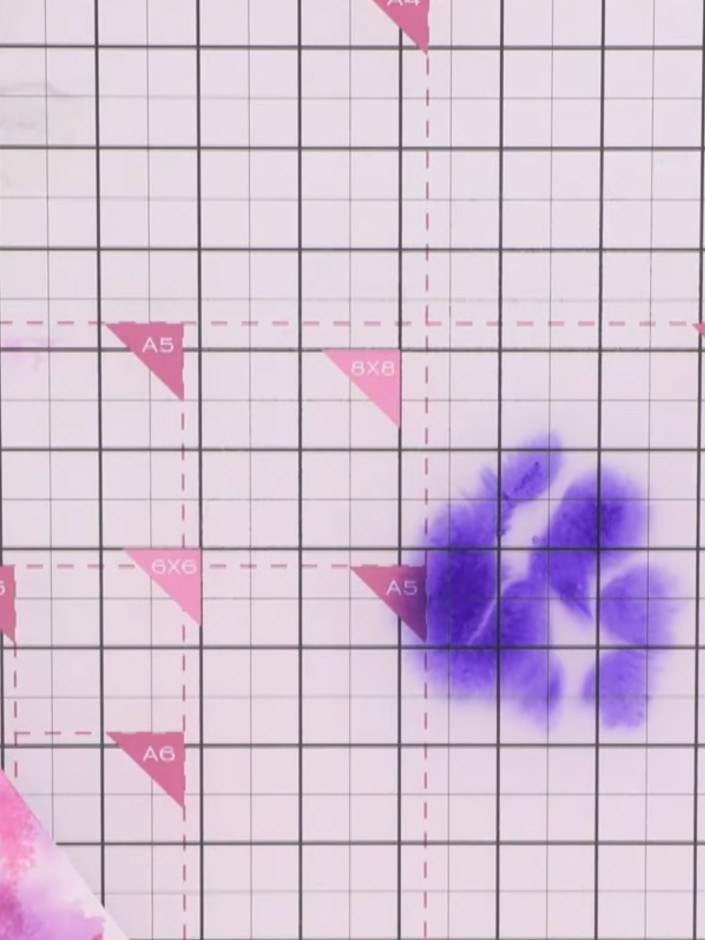 Step 6: Dip your fingers into additional ink colours, such as blue, and flick them onto the card to create splatter te