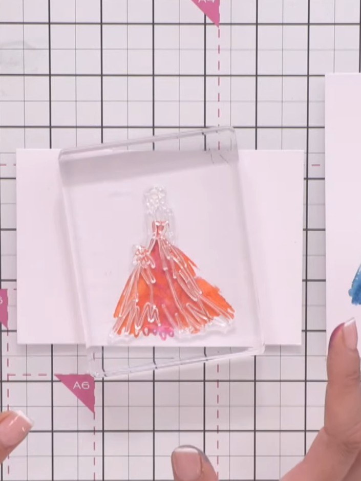 Step 7: Stamp the outline portion of the gown in black ink over the dried watercolour base, carefully lining up the bo