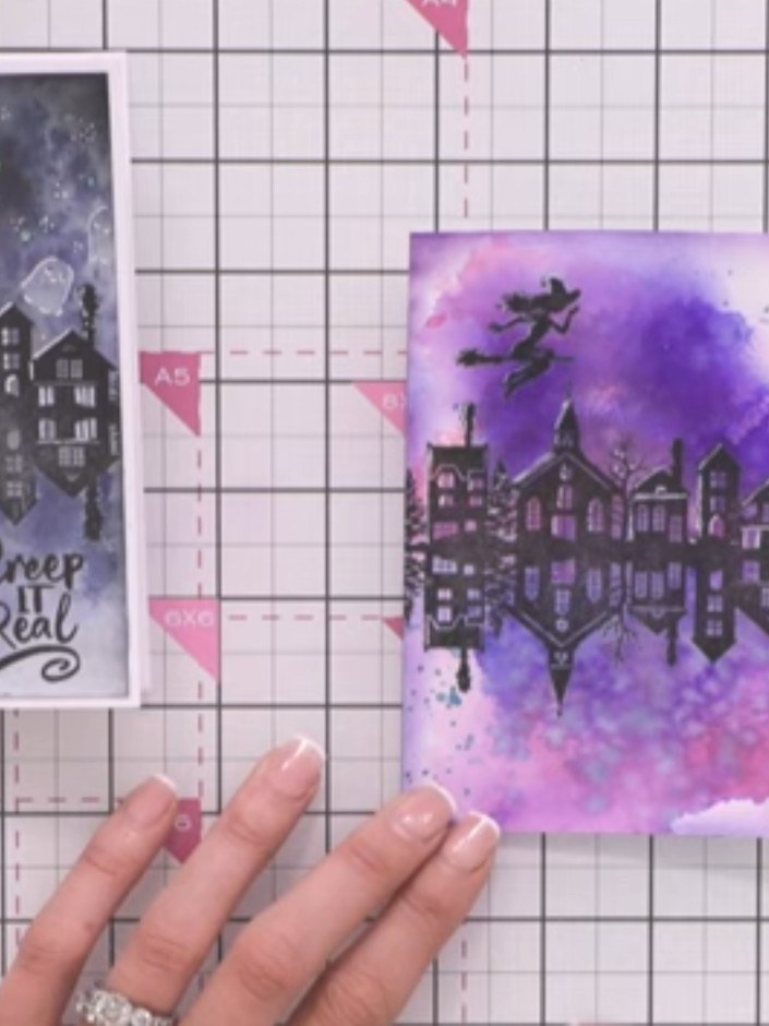 Step 10: Stamp the 'Creep it Real' sentiment in black ink at the base of the card, positioning it in the lower right co
