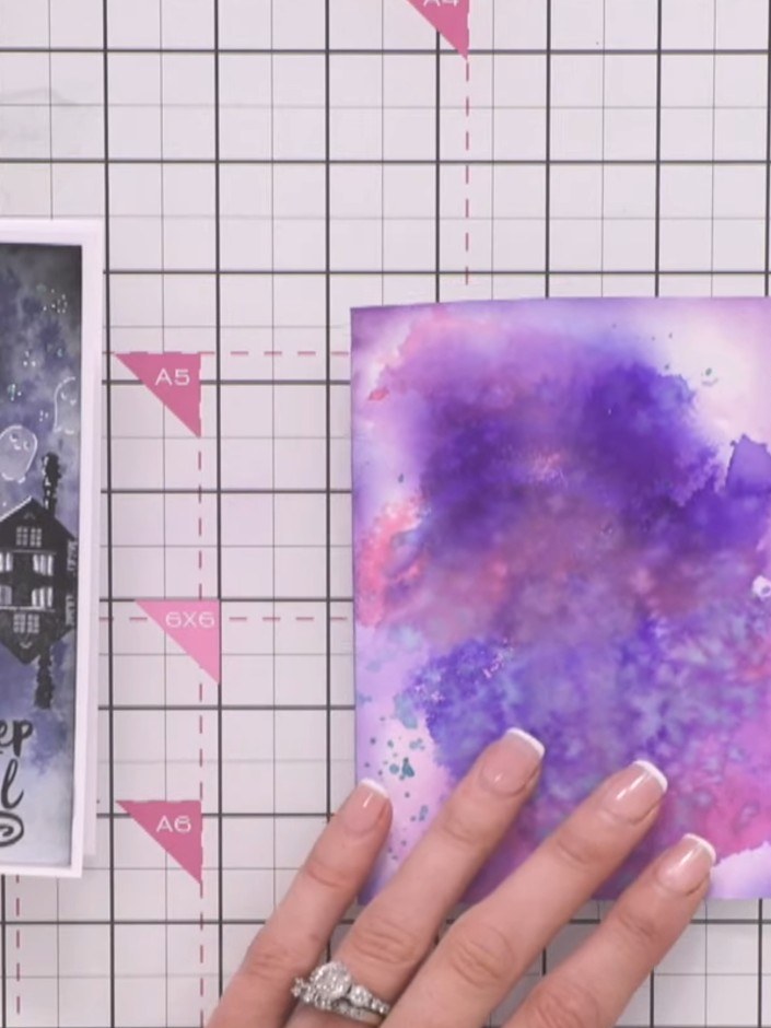Step 4: Allow the stamped haunted house image to dry completely on the purple watercolour background before proceeding