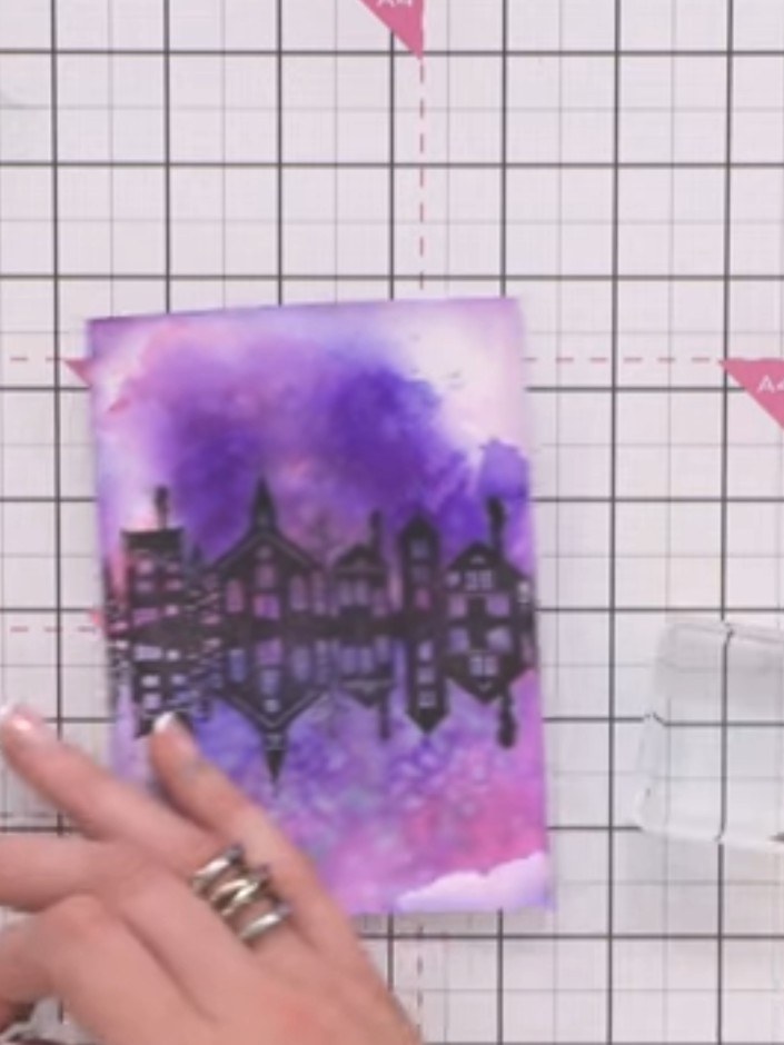 Step 5: Optionally spray the area below the building with water and blend in additional purple ink to create a water r