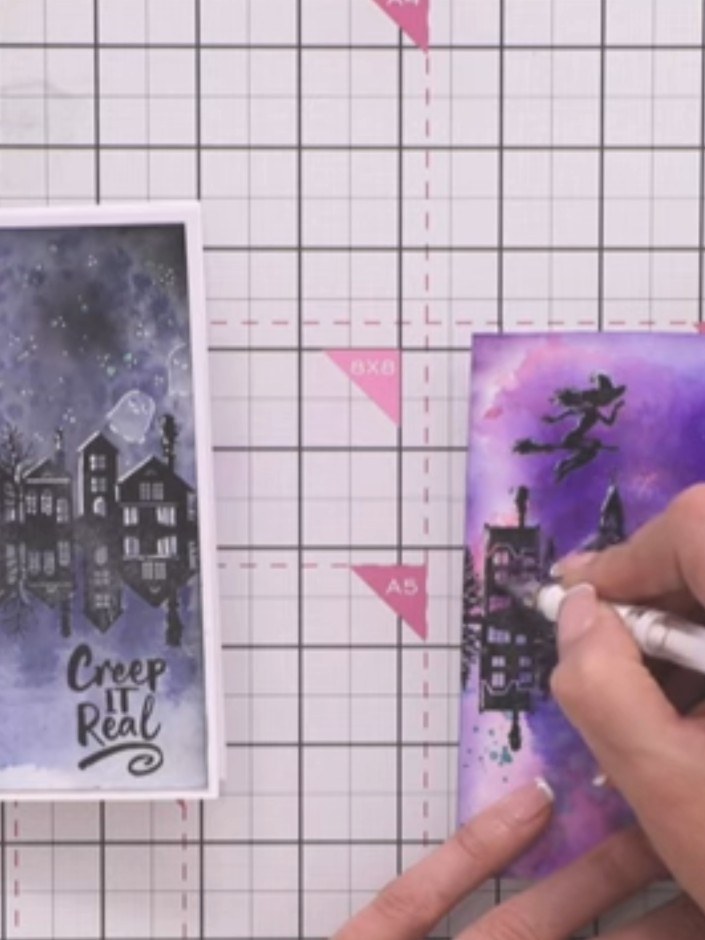 Step 9: Using a white gel pen, add fine lines in the lower area of the card to suggest ripples in the water reflection