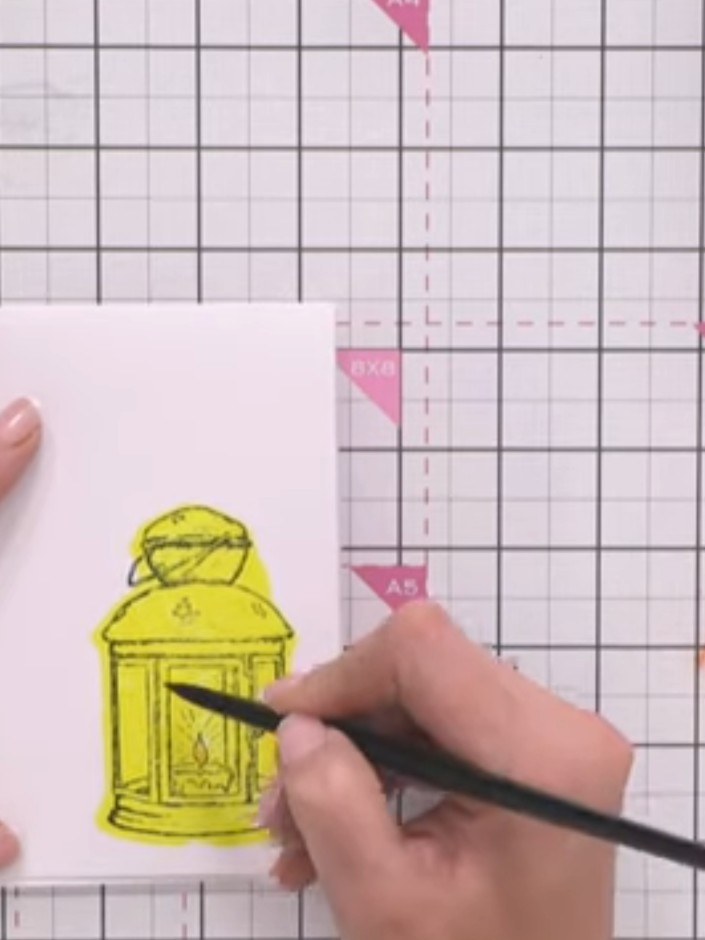 Step 10: For optional texture, add ink splatter around the yellow lantern design using your fingers. This creates addit