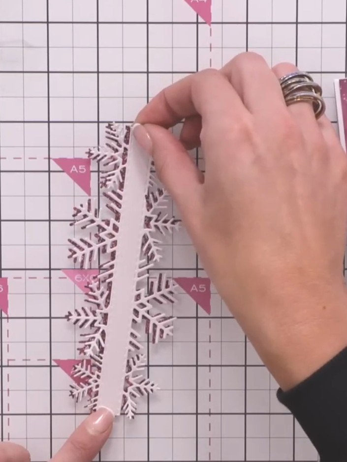 Step 5: Adhere the die-cut snowflake border to the right-hand side of your card base, positioning it vertically along 