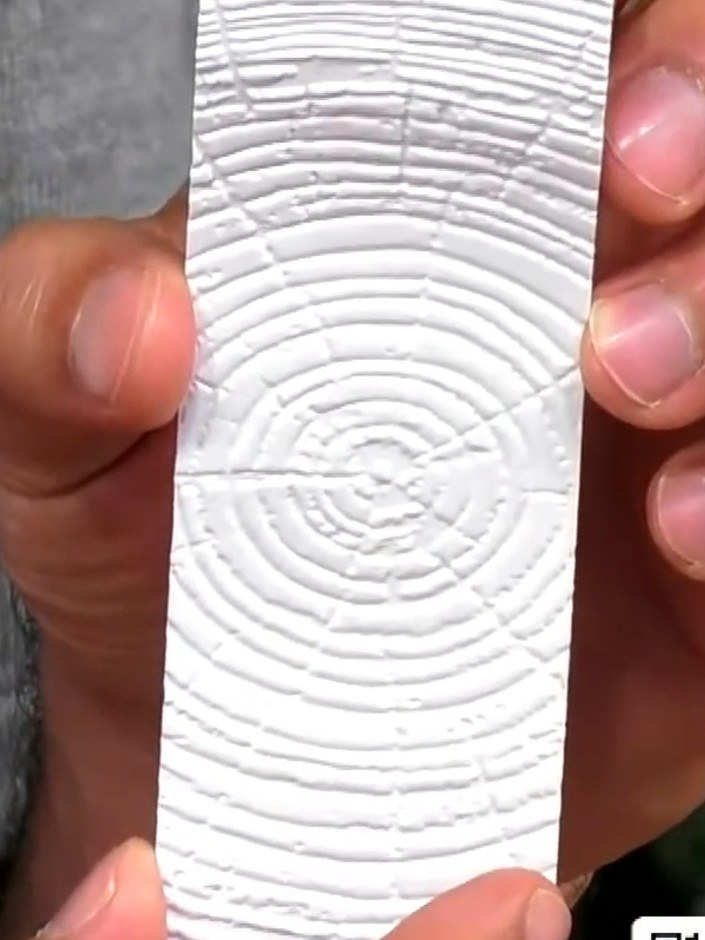 Step 3: Carefully lift the embossed white panel from the embossing folder to reveal the detailed timber ring texture p