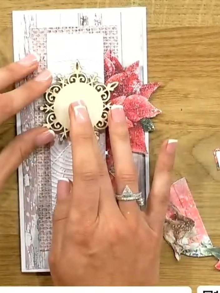 Step 7: Take a decorative circular embellishment and cut it in half. Position one half on the card to add dimension to