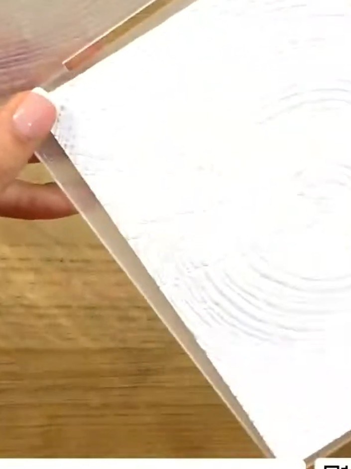 Step 3: Cut out the poinsettia and greenery elements from the vellum sheet. These decorative pieces will be used to em