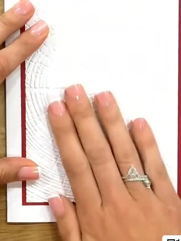 Step 7: Attach the embossed vellum panel to the card front using small amounts of adhesive in the corners. Press down 