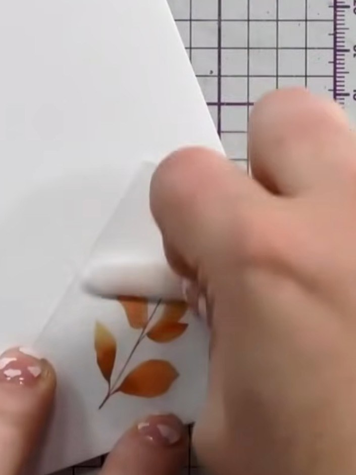 Step 4: Using a bone folder, lolly stick or ballpoint pen, rub firmly over the rubon transfer to apply the autumn leaf
