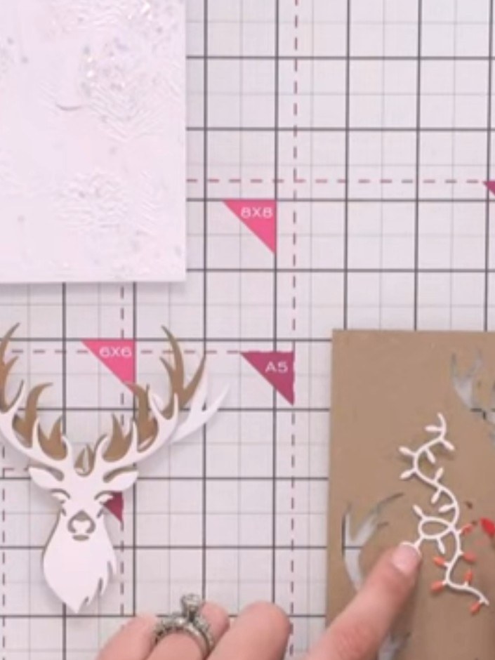 Step 10: Using red pens, colour the tips of the light bulbs on the light formation die-cut pieces to create a festive e