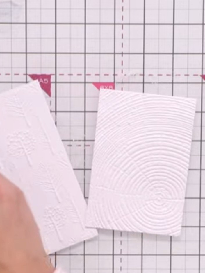 Step 4: Once the embossed panels are dry, gently rub away any excess tissue or residue that has stuck to the card surf