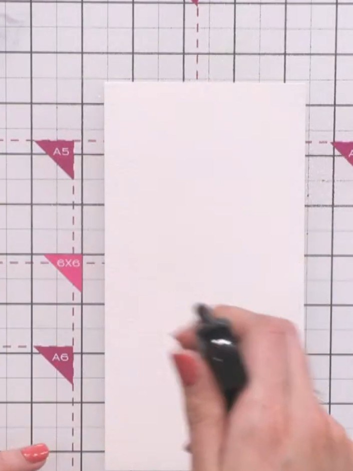 Step 2: Squeeze purple water brush pen colour onto the top of the card. Tilt the card to let the colour run down rando