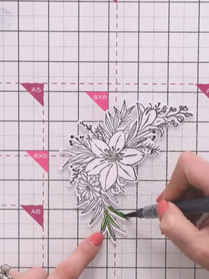 Step 9: Spray the die-cut flower with water. Using a water brush pen, paint the leaves with green, leaving white space