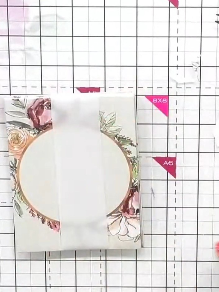 Step 8: Glue the fussy-cut floral element over the join where the belly band meets, positioning it centrally to hide t