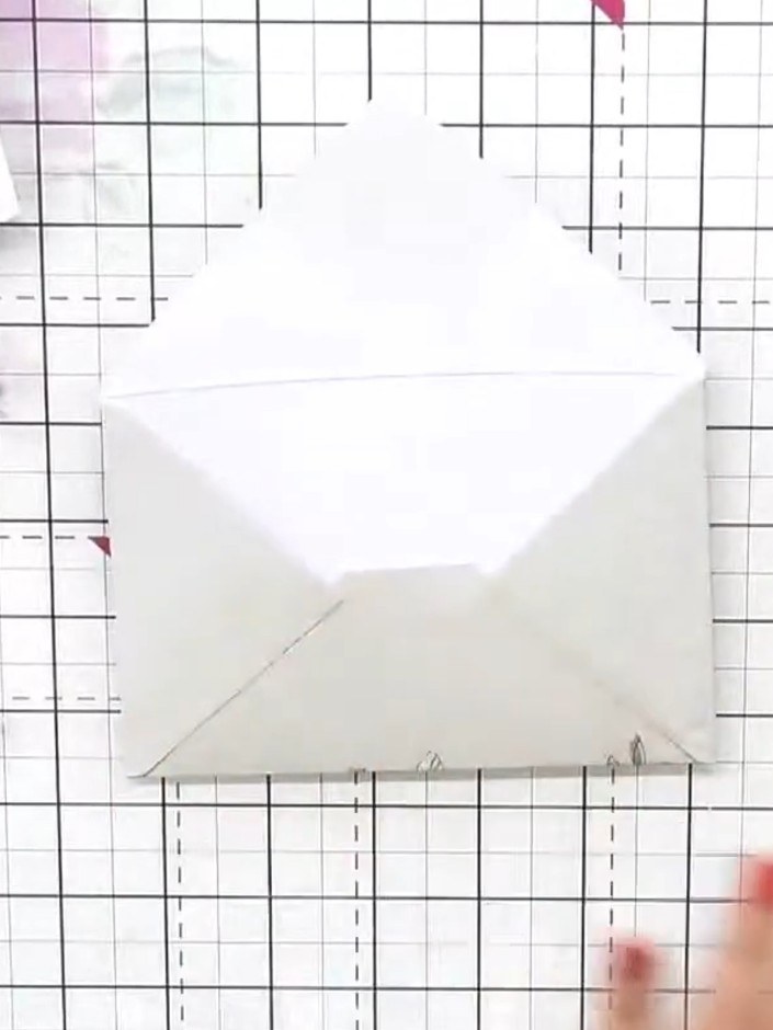 Step 1: Take one of the pre-printed envelopes and fold along all the score lines. Apply adhesive to the side and botto