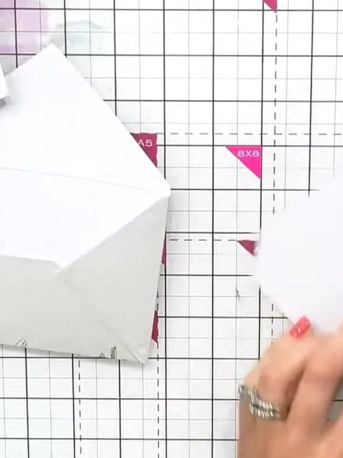 Step 2: Fold a second envelope in exactly the same way as the first, creasing along the score lines to create the fold