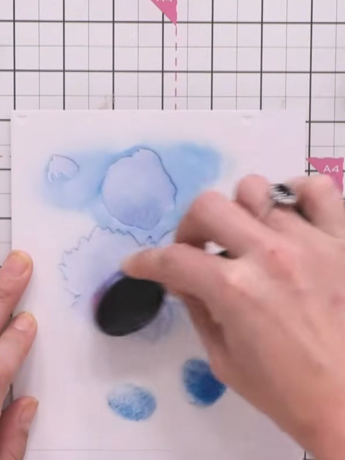 Step 2: Position stencil number two over your card and apply blue ink using a blending tool with slightly more pressur