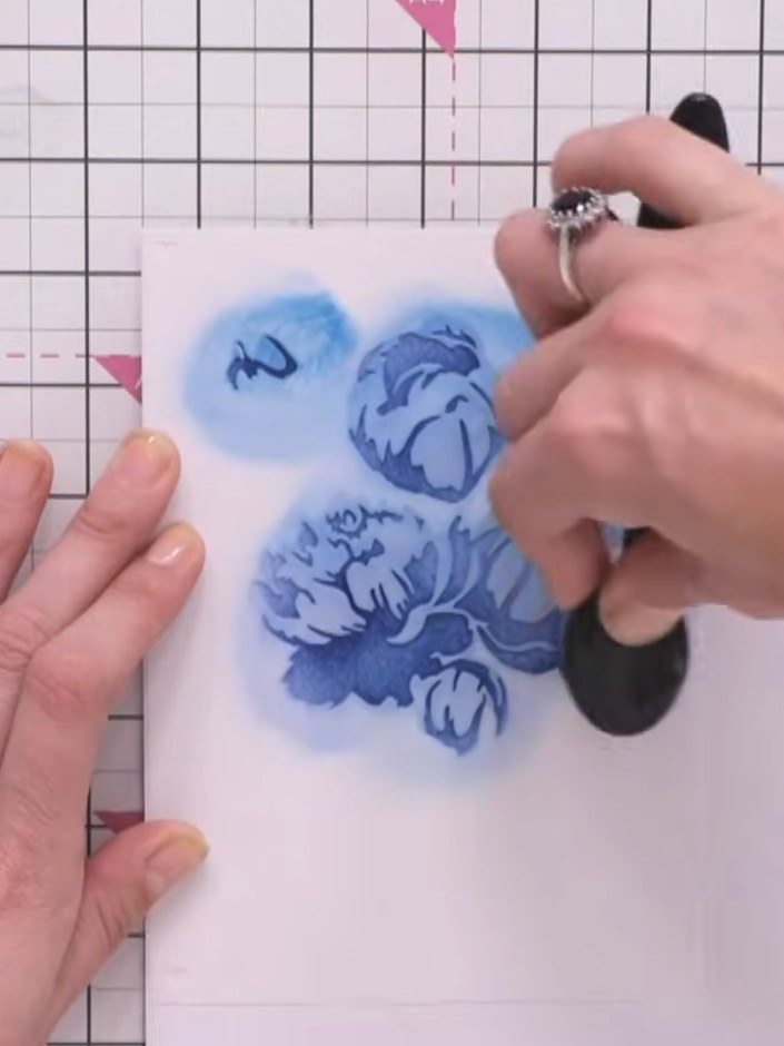 Step 3: Apply the third stencil layer using green ink, pressing slightly harder to build up colour depth on the peony 