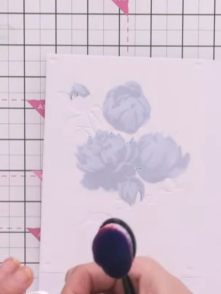 Step 4: Apply stencil number four using the same green ink pad. Press quite firmly through the stencil to create the d