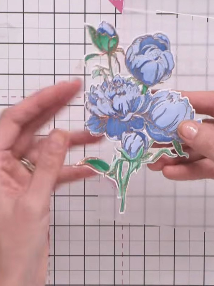 Step 9: Layer your embossed peony piece onto cream card using foam pads for dimension. The coloured floral design shou