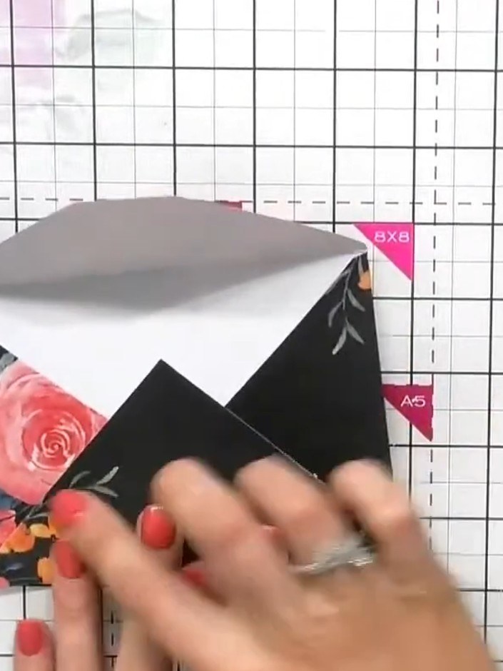 Step 1: Take a pre-scored envelope from the pack and unfold it completely on your craft mat with the printed side faci