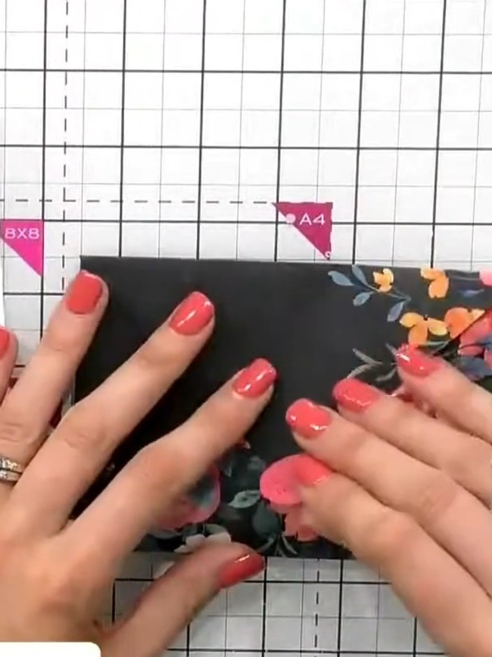 Step 7: Select a coordinating sticker from the collection and apply it to the back flap of the folded envelope to seal
