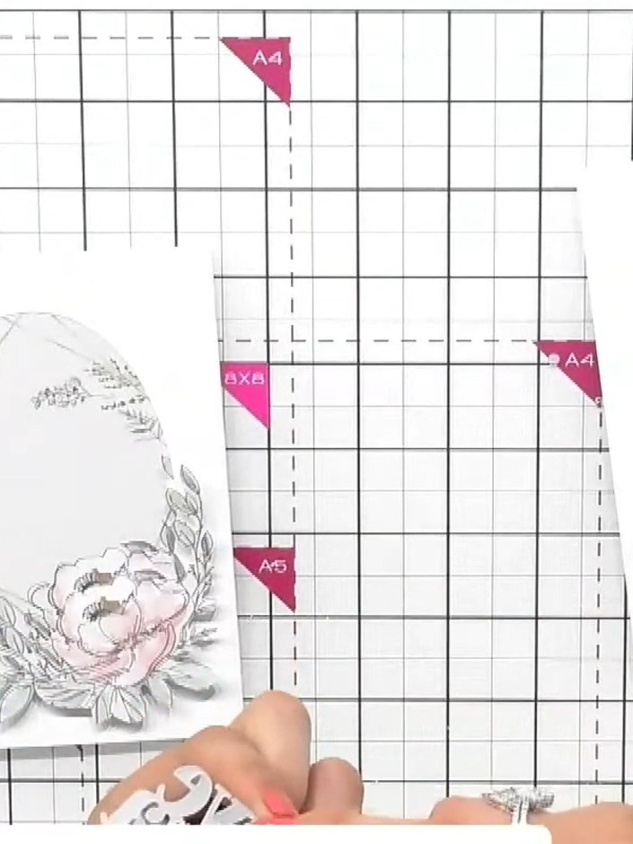 Step 3: Position the fussy-cut flower topper behind the aperture window and glue it in place from behind, ensuring the