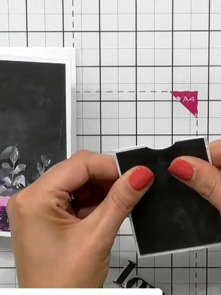 Step 4: Create a pocket by applying adhesive to three sides of a black cardstock piece, leaving the top edge open. Pre