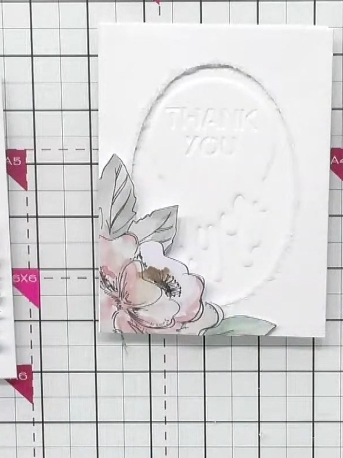 Step 3: Glue the pink floral element to the card front as your base layer. Position it centrally on the white oval pan